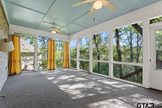 unfurnished sunroom featuring ceiling fan