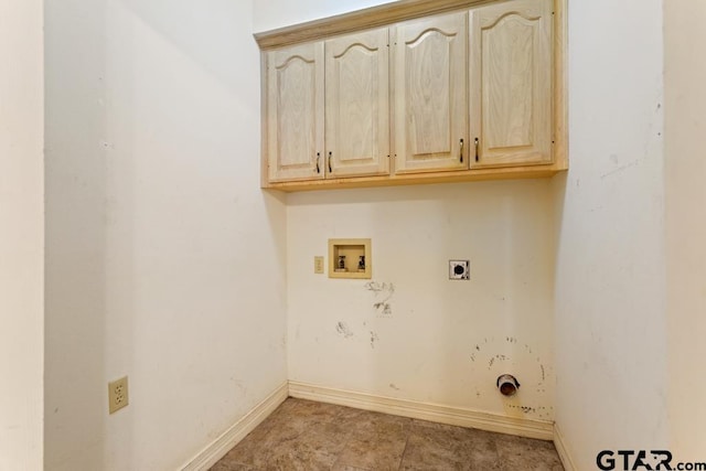 clothes washing area with washer hookup, cabinets, and hookup for an electric dryer