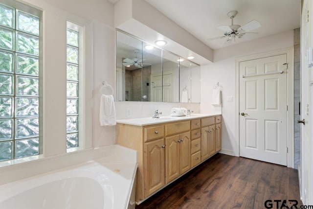 bathroom featuring a bathing tub, ceiling fan, vanity, and hardwood / wood-style flooring