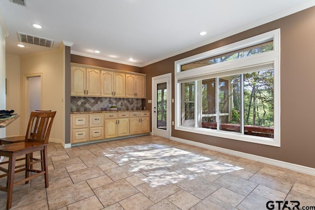 kitchen featuring decorative backsplash, light brown cabinetry, and ornamental molding