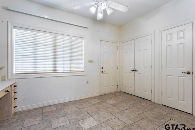 interior space featuring ceiling fan