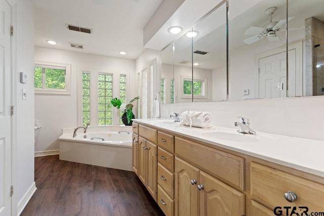 bathroom featuring separate shower and tub, ceiling fan, vanity, and hardwood / wood-style flooring