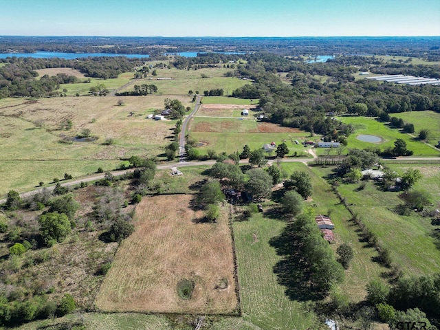 birds eye view of property with a water view and a rural view