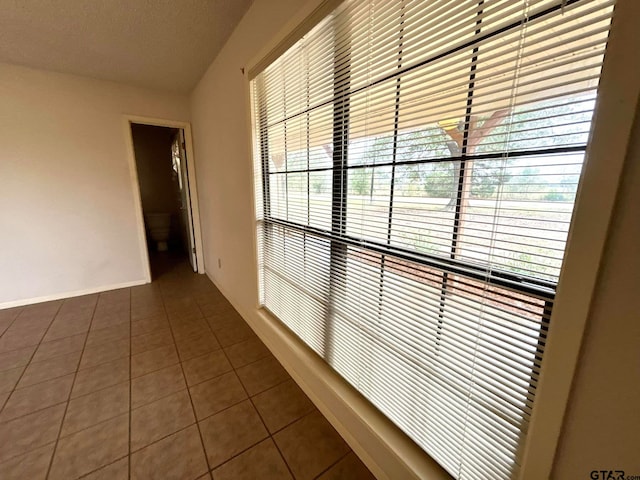 corridor featuring dark tile patterned floors