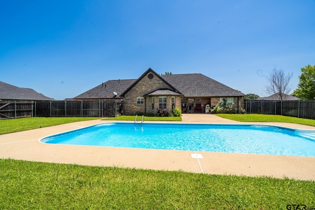 view of pool with a yard and a patio area