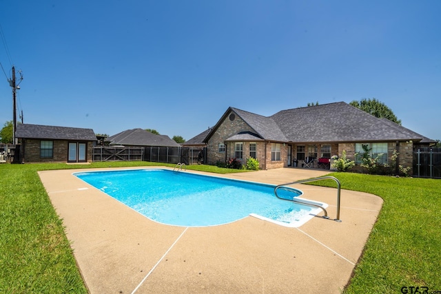 view of pool featuring a patio and a lawn