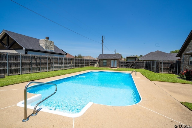 view of swimming pool with a yard and a storage shed