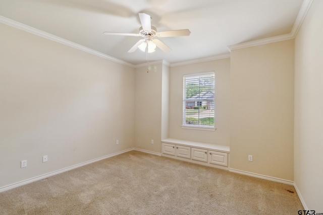 unfurnished room with baseboards, light colored carpet, crown molding, and ceiling fan