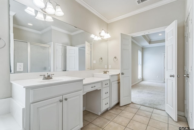 bathroom with double vanity, ornamental molding, tile patterned floors, a shower stall, and a sink