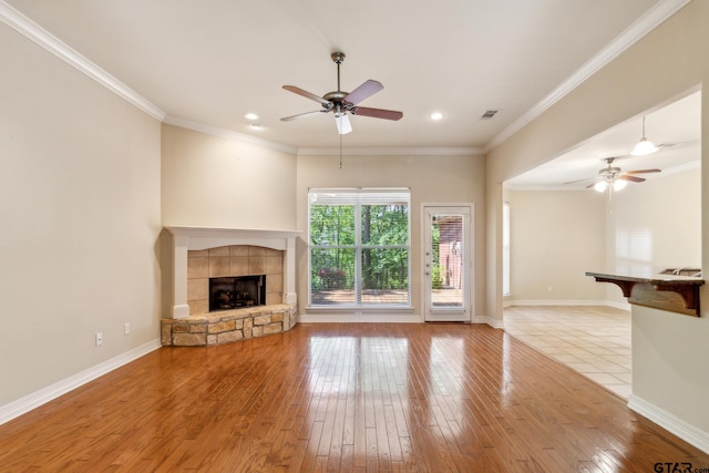 unfurnished living room featuring a fireplace, light wood-style flooring, visible vents, and ceiling fan