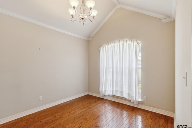 spare room featuring hardwood / wood-style floors, an inviting chandelier, ornamental molding, and lofted ceiling