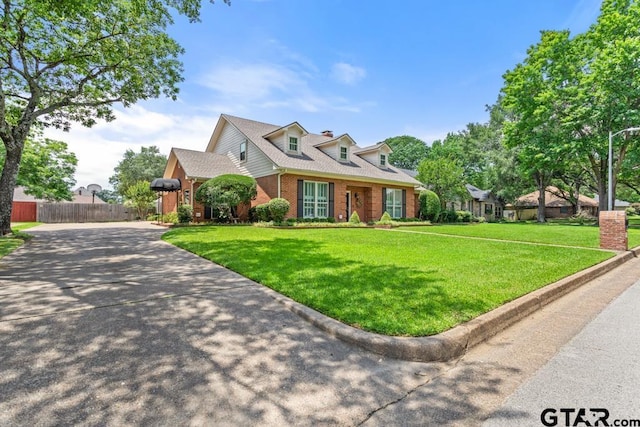 5807 Stoneleigh Dr, Tyler, TX 75703 - cape cod-style house featuring brick siding and driveway