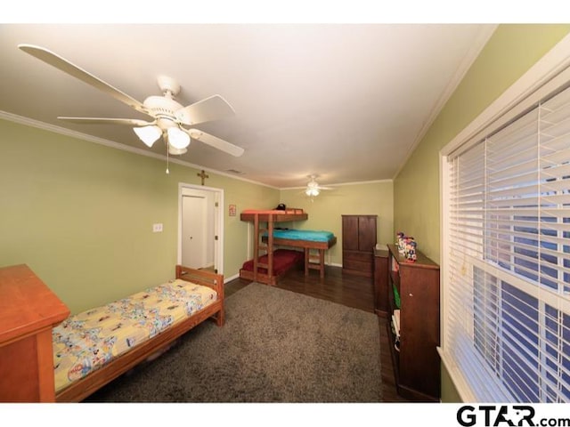 carpeted bedroom featuring ceiling fan and crown molding