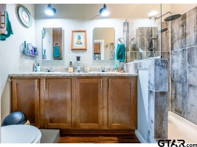 bathroom featuring walk in shower, vanity, and toilet