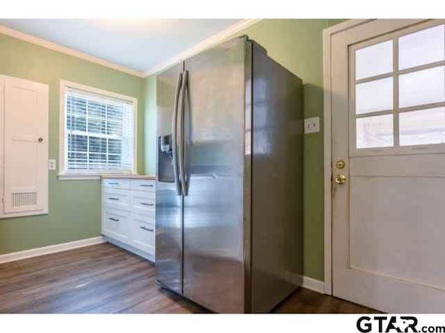 kitchen featuring dark hardwood / wood-style flooring, ornamental molding, stainless steel refrigerator with ice dispenser, and white cabinetry