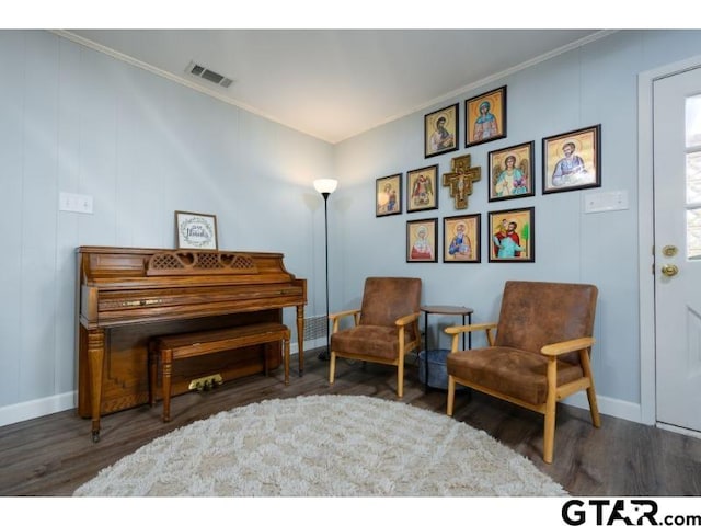 living area with dark wood-type flooring and crown molding