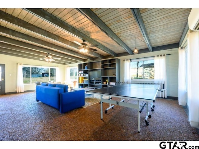 playroom with a wall unit AC, carpet, plenty of natural light, and beamed ceiling