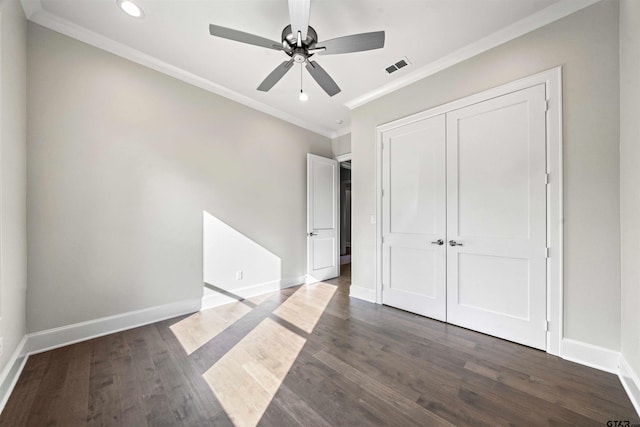 unfurnished bedroom with dark hardwood / wood-style flooring, ceiling fan, and ornamental molding