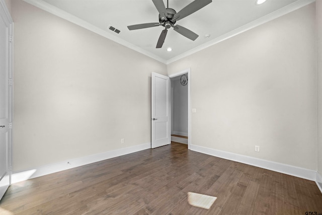 empty room featuring crown molding, ceiling fan, and dark hardwood / wood-style floors