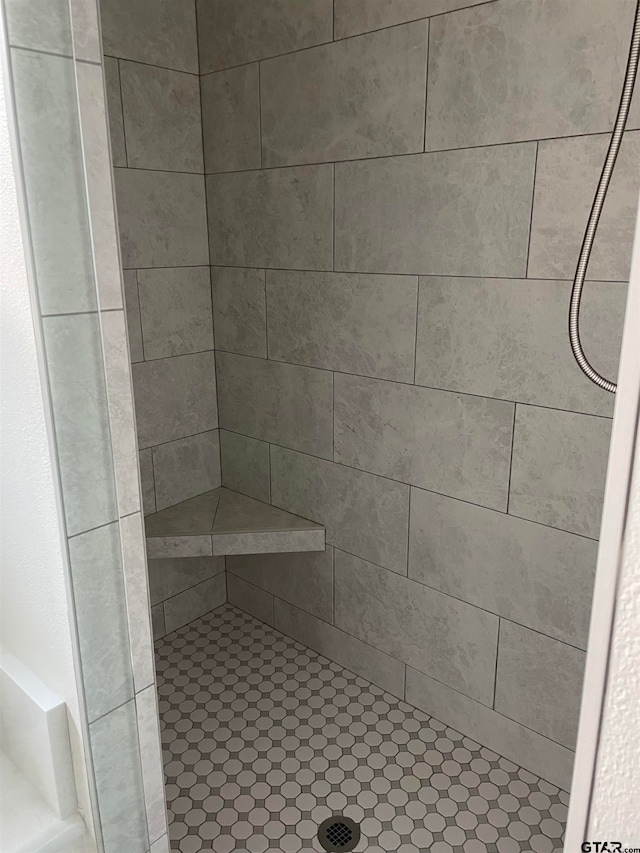 bathroom with tiled shower