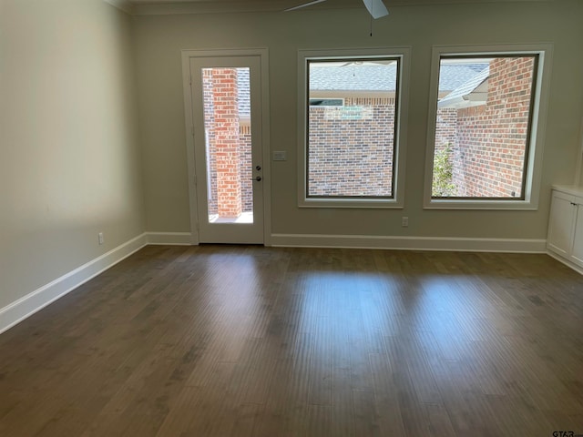 unfurnished room featuring ceiling fan and dark wood-type flooring