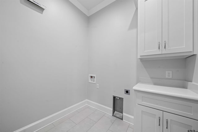 clothes washing area featuring electric dryer hookup, hookup for a washing machine, light tile patterned flooring, and cabinets