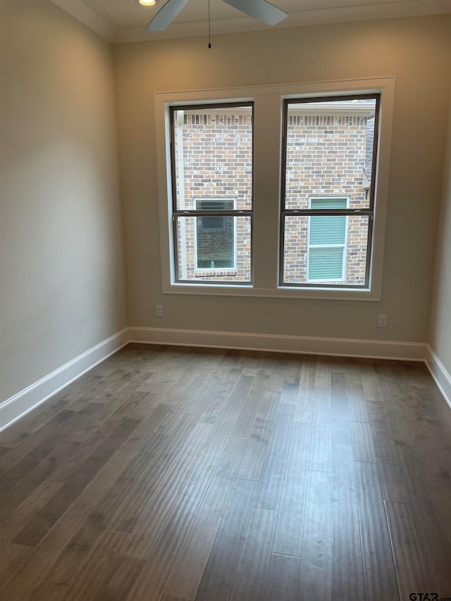 spare room with dark hardwood / wood-style floors and ceiling fan