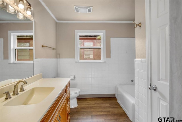 1330 Graham Dr, Tyler, TX 75701 - full bathroom featuring tile walls, toilet, ornamental molding, visible vents, and vanity