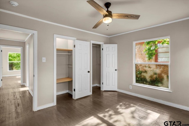 1330 Graham Dr, Tyler, TX 75701 - unfurnished bedroom with wood finished floors, ornamental molding, ceiling fan, a spacious closet, and baseboards
