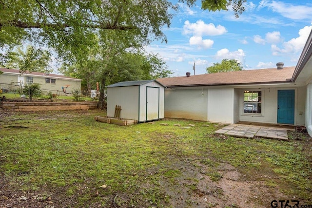 1330 Graham Dr, Tyler, TX 75701 - exterior space featuring a lawn, an outbuilding, fence, and a storage unit