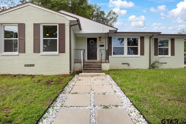 1330 Graham Dr, Tyler, TX 75701 - split level home featuring a front lawn, brick siding, and crawl space