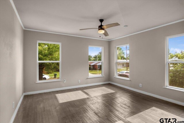 1330 Graham Dr, Tyler, TX 75701 - empty room with a wealth of natural light, wood finished floors, baseboards, and ceiling fan