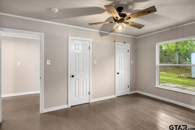 1330 Graham Dr, Tyler, TX 75701 - unfurnished bedroom featuring wood finished floors, baseboards, and ornamental molding