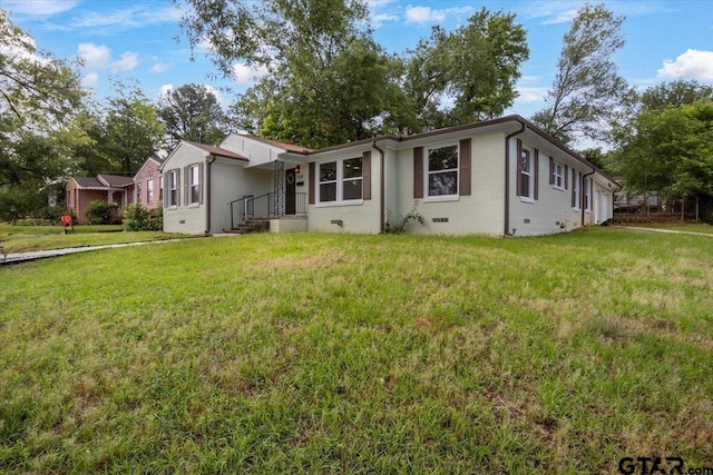 1330 Graham Dr, Tyler, TX 75701 - view of front facade with a front lawn and brick siding