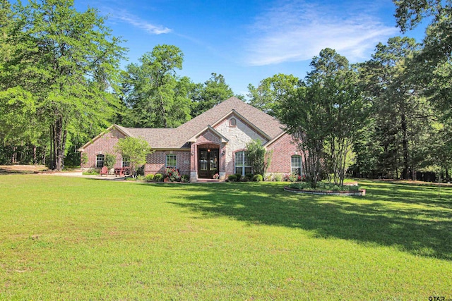 24130 Stallion Park Pl, Lindale, TX 75771 - ranch-style home featuring a front yard, brick siding, and stone siding