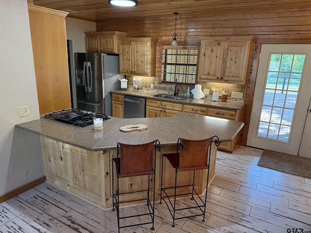 1801 Robbins Rd, Athens, TX 75751 - kitchen with light wood-type flooring, stainless steel appliances, a breakfast bar, and a sink