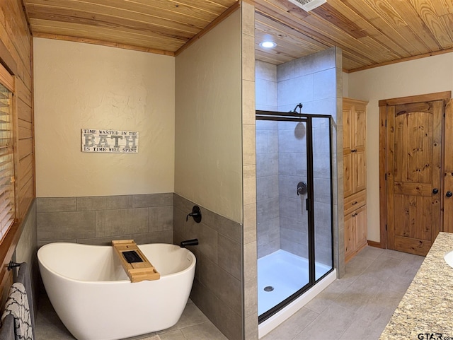 1801 Robbins Rd, Athens, TX 75751 - bathroom with a shower stall, wooden ceiling, a freestanding bath, and tile patterned flooring