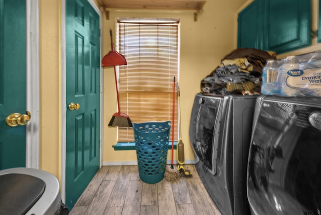 laundry area with hardwood / wood-style floors and washing machine and clothes dryer