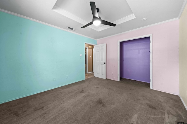 unfurnished bedroom with a closet, ceiling fan, crown molding, and dark carpet