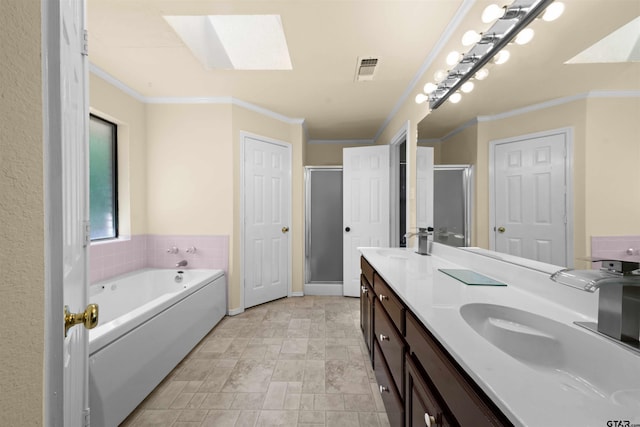 bathroom featuring crown molding, vanity, a skylight, and independent shower and bath