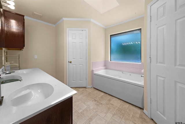 bathroom with ornamental molding, vanity, and a tub to relax in