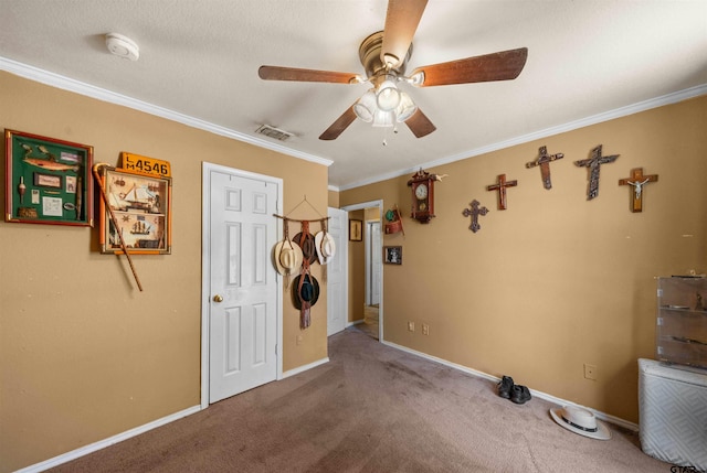 unfurnished bedroom featuring carpet floors, ceiling fan, and crown molding