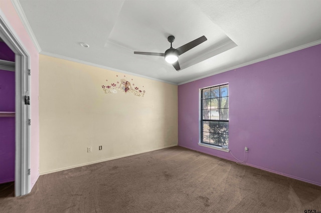 empty room with ornamental molding, carpet, and ceiling fan