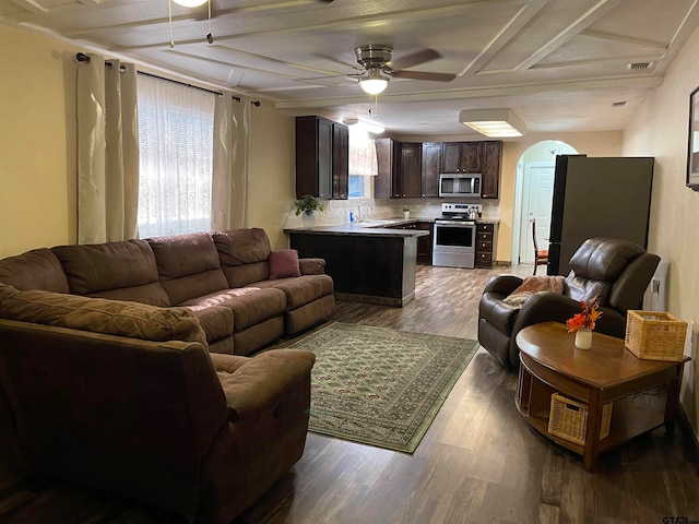 living room with hardwood / wood-style floors, ceiling fan, and sink