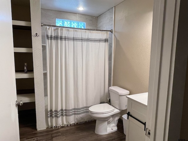 bathroom featuring a shower with shower curtain, wood-type flooring, vanity, and toilet