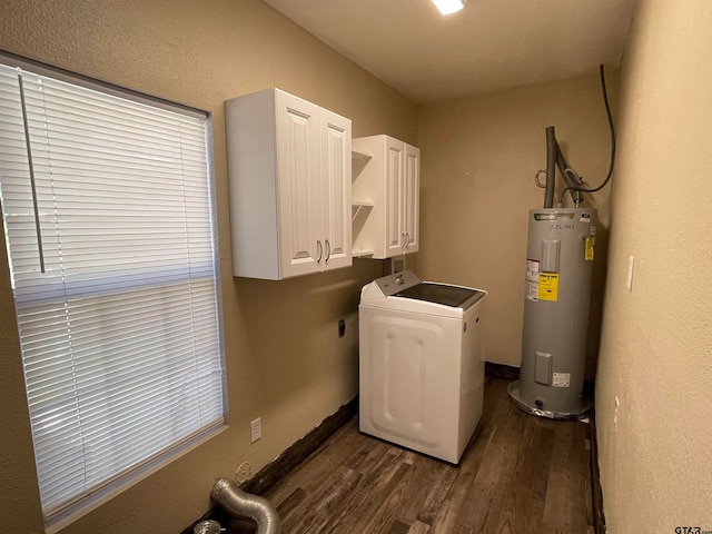 laundry area featuring electric water heater, dark wood-type flooring, cabinets, and washer / dryer