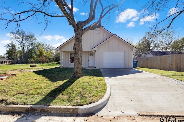 view of front of property with a garage and a front lawn