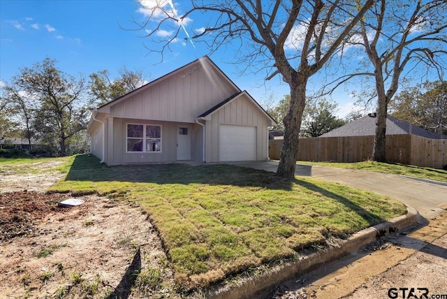 ranch-style home featuring a garage and a front yard