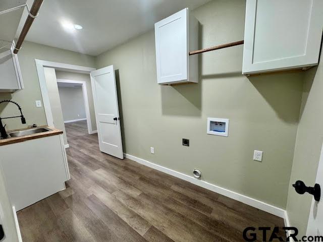 641 N Weldon St, Frankston, TX 75763 - clothes washing area with cabinet space, washer hookup, hookup for an electric dryer, wood finished floors, and baseboards
