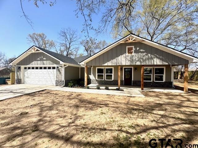 641 N Weldon St, Frankston, TX 75763 - view of front of property featuring stone siding, an attached garage, board and batten siding, and driveway